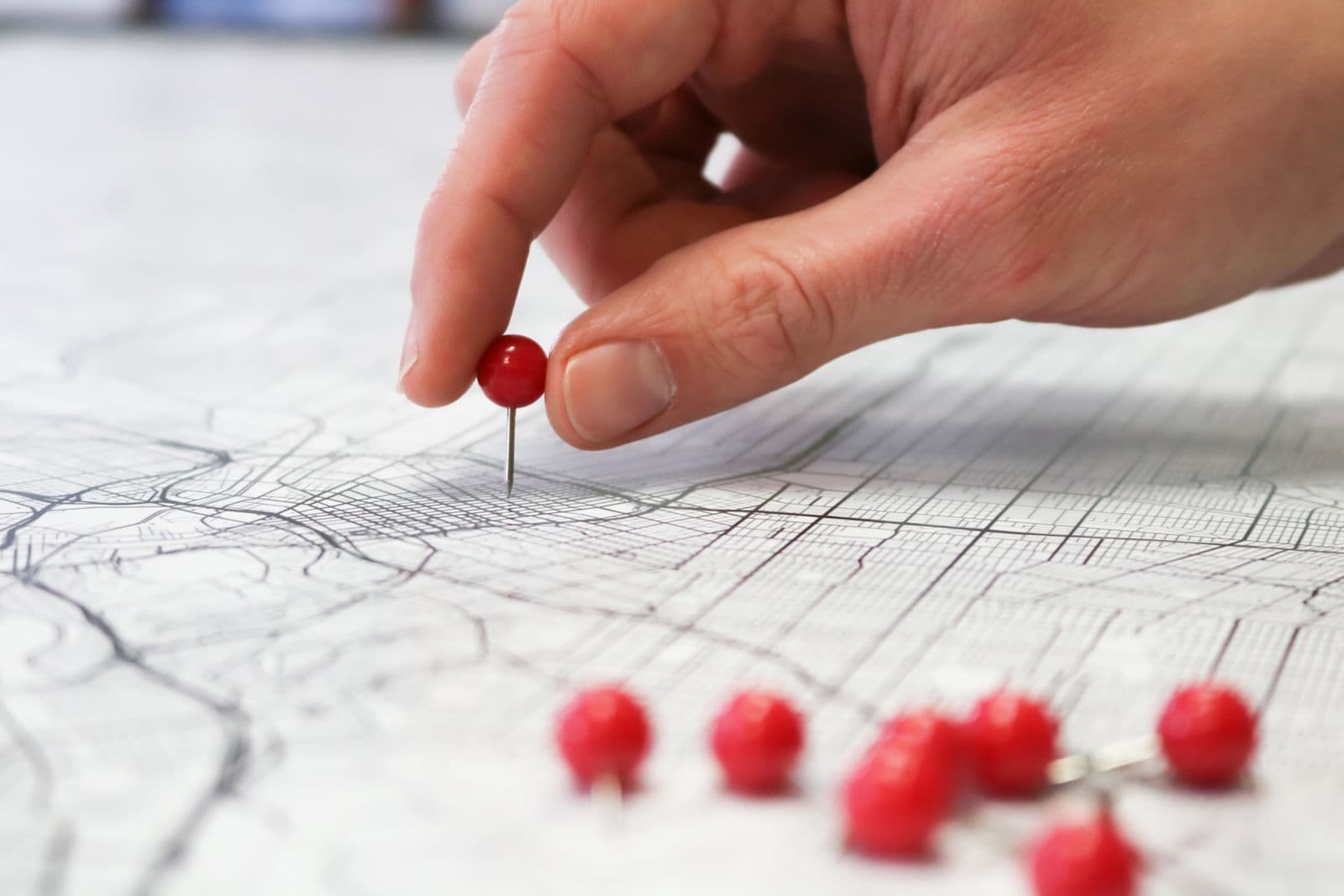 A smartphone showing a map with business location pins in a local search result