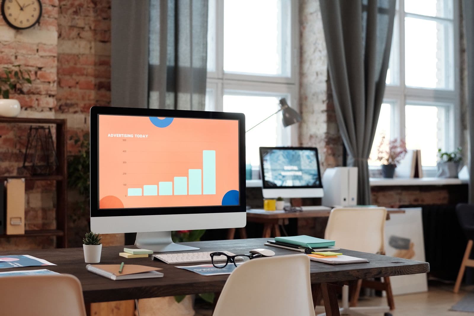 A campaign performance dashboard on a laptop screen showing spend, conversions and cost per acquisition charts