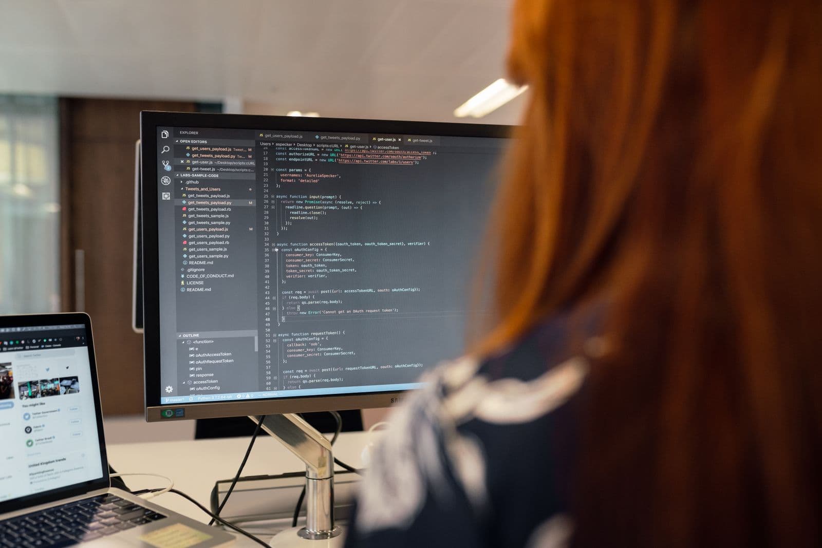 A developer reviewing code produced by an AI coding agent on a monitor