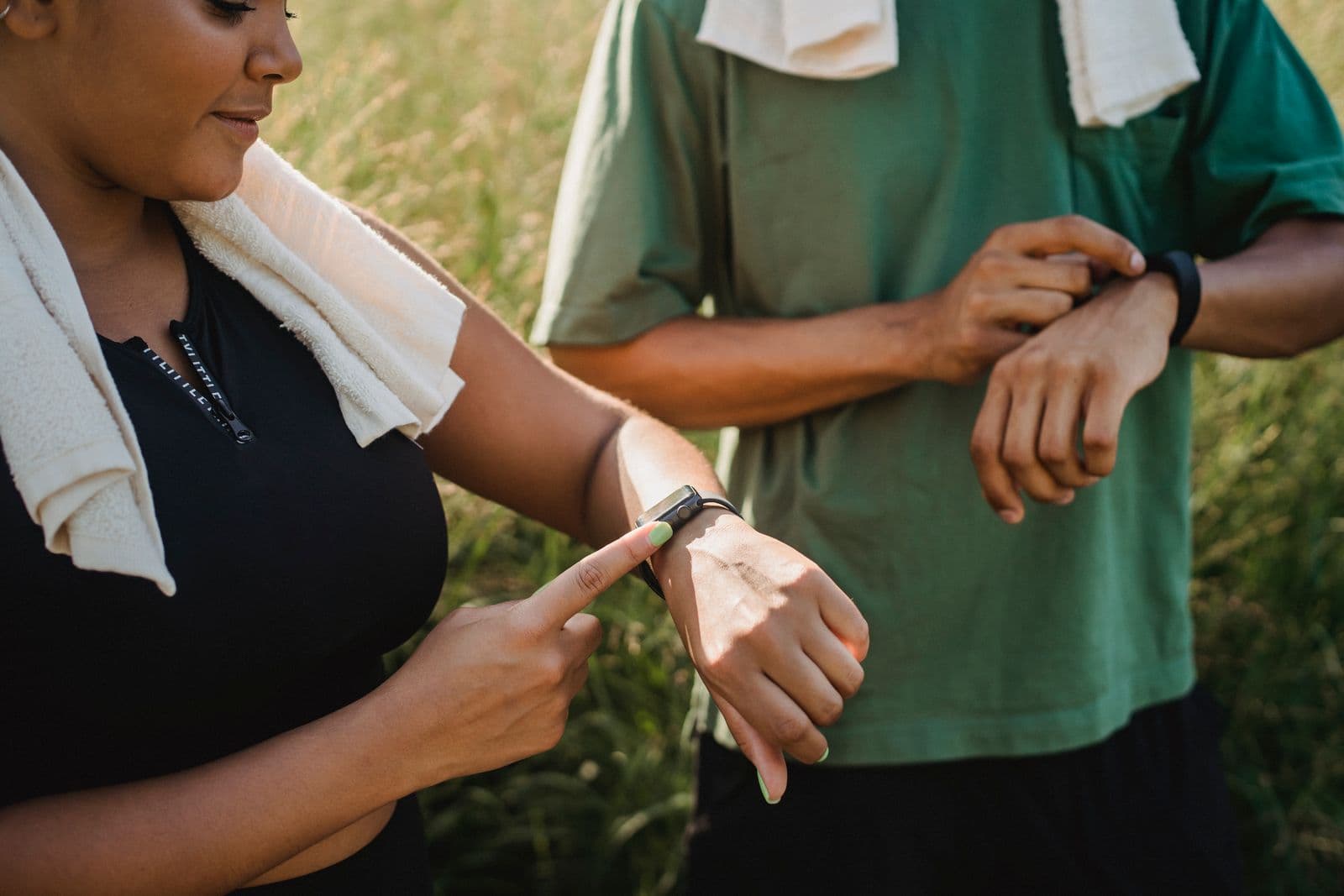 A person checking a fitness tracker on their wrist during a workout