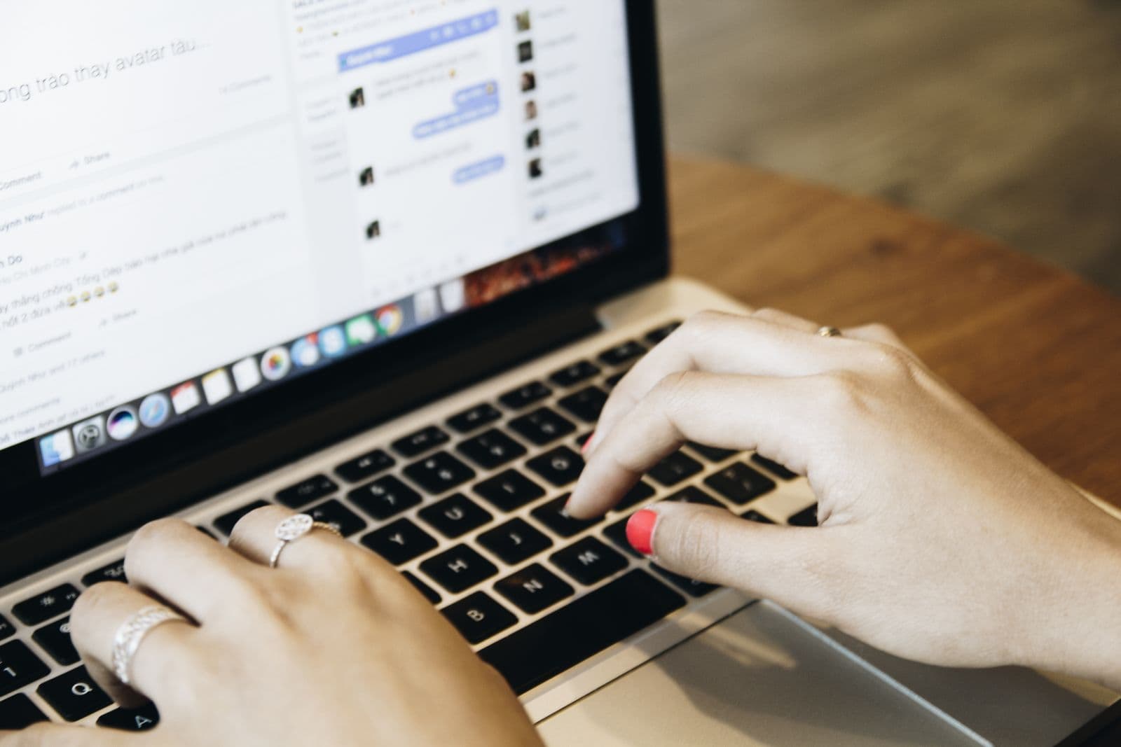 A person typing in a website live chat support window on a laptop screen