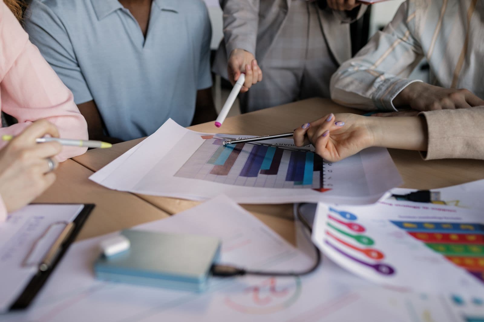 A marketing workspace with a content calendar, analytics charts and campaign notes spread across a desk