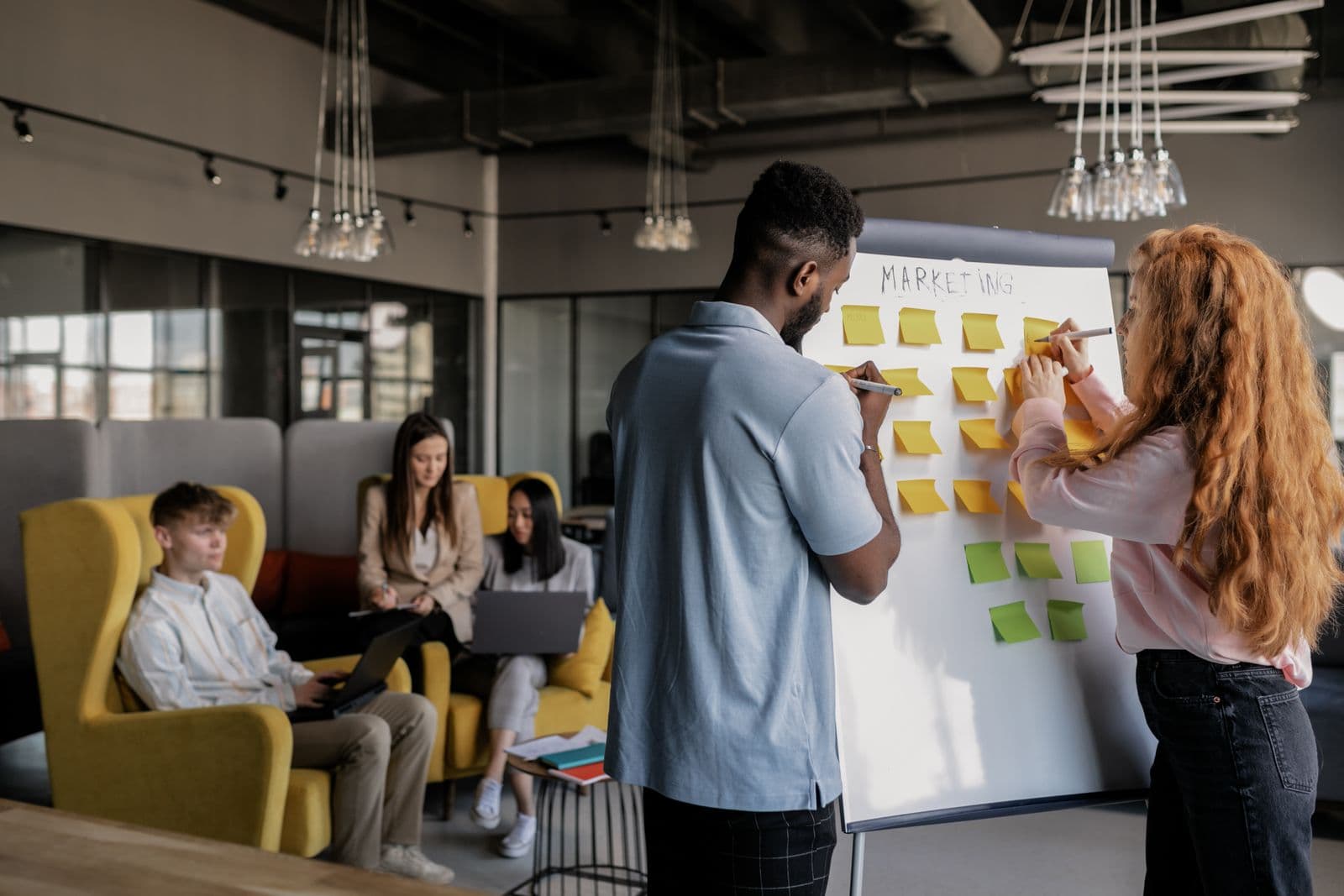 A team mapping an AI workflow together around screens before building the automation